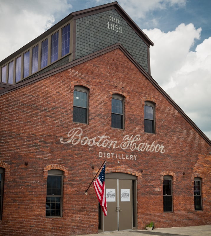 A brick building with the words boston harbor distillery written on it.